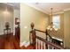Upstairs hallway with hardwood floors, a chandelier, and natural light, offering a view of the home's entrance at 4991 Sound View Dr, Mount Pleasant, SC 29466