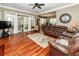 Spacious living area with hardwood floors, French doors, and a comfortable brown leather sofa at 4991 Sound View Dr, Mount Pleasant, SC 29466