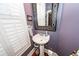 Charming powder room features a pedestal sink, decorative mirror, and shuttered window for natural light at 4991 Sound View Dr, Mount Pleasant, SC 29466