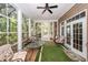 Bright sunroom with large windows, ceiling fan, and cozy seating area overlooking the outdoor landscape at 4991 Sound View Dr, Mount Pleasant, SC 29466
