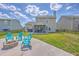 Large backyard with a patio, Adirondack chairs, and an enclosed porch perfect for entertaining and relaxation at 5032 Ballantine Dr, Summerville, SC 29485