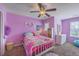Bright bedroom with vibrant decor, including a colorful bedspread, playful wall art, and coordinated storage solutions at 5032 Ballantine Dr, Summerville, SC 29485