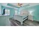 This bedroom features light blue walls, a ceiling fan and grey wood floors for a tranquil and relaxing atmosphere at 5032 Ballantine Dr, Summerville, SC 29485