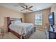 Cozy bedroom featuring a dark wood frame bed and furniture illuminated with neutral colored walls and natural light at 5032 Ballantine Dr, Summerville, SC 29485