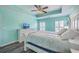 Primary bedroom with accent tray ceiling, neutral color palette, shutters, ceiling fan and wood-look floors at 5032 Ballantine Dr, Summerville, SC 29485
