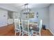 Elegant dining area with a rustic table, stylish chandelier, and modern decor at 5032 Ballantine Dr, Summerville, SC 29485