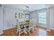Elegant dining area with a rustic table, stylish chandelier, and modern decor at 5032 Ballantine Dr, Summerville, SC 29485