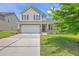 Charming two-story home with a well-manicured lawn, a two-car garage, and a welcoming front porch at 5032 Ballantine Dr, Summerville, SC 29485
