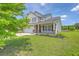 Charming two-story home with a well-manicured lawn, a two-car garage, and a welcoming front porch at 5032 Ballantine Dr, Summerville, SC 29485