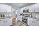 Modern kitchen features white cabinets, subway tile backsplash, and stainless steel appliances at 5032 Ballantine Dr, Summerville, SC 29485