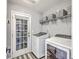 Well-equipped laundry room with washer, dryer, wire shelves and access to the outside at 5032 Ballantine Dr, Summerville, SC 29485