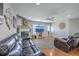 Comfortable living room with wood floors, fireplace, large clock, and black leather couches at 5032 Ballantine Dr, Summerville, SC 29485