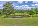 Picturesque pond surrounded by lush greenery and trees offers a peaceful and scenic view at 5032 Ballantine Dr, Summerville, SC 29485
