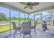 Enclosed porch featuring a dining table and chairs provide an outdoor dining experience, complete with a ceiling fan at 5032 Ballantine Dr, Summerville, SC 29485