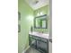 Stylish powder room with modern vanity and framed mirror next to the front entry at 5032 Ballantine Dr, Summerville, SC 29485