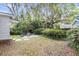 Spacious backyard with a patio area, surrounded by lush greenery and mature trees at 5075 Walker St, North Charleston, SC 29405