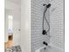 Modern bathroom with white subway tile, black fixtures, and a stylish black and white patterned tile floor at 5075 Walker St, North Charleston, SC 29405