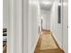 Hallway with white walls, hardwood flooring, and an area rug at 5075 Walker St, North Charleston, SC 29405