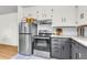 Modern kitchen with stainless steel appliances, contrasting cabinetry, and open shelving at 5075 Walker St, North Charleston, SC 29405
