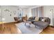 Bright living room with hardwood floors, cozy seating, and natural light from the large window at 5075 Walker St, North Charleston, SC 29405