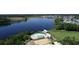 Aerial view featuring a lakeside pool, community buildings, lush green spaces, and residential area at 508 Alderly Dr, Moncks Corner, SC 29461