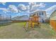 Lush backyard features a trampoline, a playset, and a wooden privacy fence at 508 Alderly Dr, Moncks Corner, SC 29461
