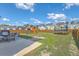 Wide-open backyard with patio set, playset, trampoline, and privacy fence at 508 Alderly Dr, Moncks Corner, SC 29461