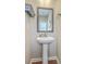 Bathroom featuring a pedestal sink, decorative mirror, and hardwood floors at 508 Alderly Dr, Moncks Corner, SC 29461