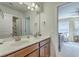Bathroom with a double sink vanity, a large mirror, and a door that leads to the next room at 508 Alderly Dr, Moncks Corner, SC 29461