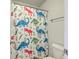 Cheerful bathroom with a toilet and a dinosaur-themed shower curtain at 508 Alderly Dr, Moncks Corner, SC 29461