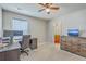 This bedroom has a ceiling fan, a window, a desk with a computer, and a bathroom at 508 Alderly Dr, Moncks Corner, SC 29461