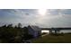Community open air pavilion with picnic tables, BBQ pit, and seating, overlooking a lake at 508 Alderly Dr, Moncks Corner, SC 29461