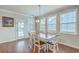 Charming dining room with hardwood floors, bright natural light, and a modern chandelier above the table at 508 Alderly Dr, Moncks Corner, SC 29461