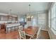 Bright dining room with windows, hardwood floors, and an open floor plan into the kitchen and living room at 508 Alderly Dr, Moncks Corner, SC 29461