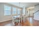 Open concept dining room with hardwood floors and natural lighting leading into the foyer and kitchen at 508 Alderly Dr, Moncks Corner, SC 29461