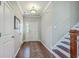 Traditional foyer with hardwood floors, staircase, and decorative rug leading to the white front door at 508 Alderly Dr, Moncks Corner, SC 29461