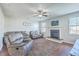 Comfortable living room with fireplace, leather seating, and a ceiling fan, creating a relaxing ambiance at 508 Alderly Dr, Moncks Corner, SC 29461