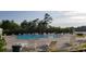 Community pool with lounge chairs overlooking a scenic pond and lush greenery at 508 Alderly Dr, Moncks Corner, SC 29461