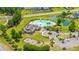 Aerial view of community pool, pond, playground, and clubhouse surrounded by lush green lawns at 511 Nandina Dr, Goose Creek, SC 29445