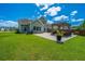 Beautiful backyard with outdoor dining and seating, featuring a healthy lawn and a custom pergola at 511 Nandina Dr, Goose Creek, SC 29445