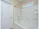 Bright bathroom features a white bathtub, shower with grab bar, and window at 511 Nandina Dr, Goose Creek, SC 29445