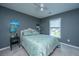 Gray bedroom with blue accents, features a comfortable bed and bright natural light at 511 Nandina Dr, Goose Creek, SC 29445