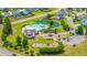 Aerial view of a community pool with sun loungers, a playground, landscaping, and surrounding homes at 511 Nandina Dr, Goose Creek, SC 29445
