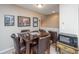 Dining area boasts a dark wood table, leather chairs, and adjacent microwave at 511 Nandina Dr, Goose Creek, SC 29445