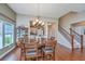 Elegant dining room with a wooden table, chandelier, and view into the kitchen and staircase at 511 Nandina Dr, Goose Creek, SC 29445