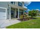 Inviting front porch adorned with colorful flowers and an American flag, offering a cozy outdoor space at 511 Nandina Dr, Goose Creek, SC 29445