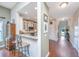 Open-concept hallway leading to a well-lit kitchen with a breakfast bar and white cabinetry at 511 Nandina Dr, Goose Creek, SC 29445