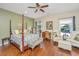Comfortable main bedroom featuring hardwood floors, ceiling fan, and bright natural lighting at 511 Nandina Dr, Goose Creek, SC 29445