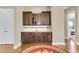 Bar area with hardwood floors, dark wood cabinets, and granite countertops at 522 Tidewater Chase Ln, Summerville, SC 29486