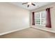 Bright bedroom with a large window, neutral carpet, and stylish maroon curtains at 522 Tidewater Chase Ln, Summerville, SC 29486